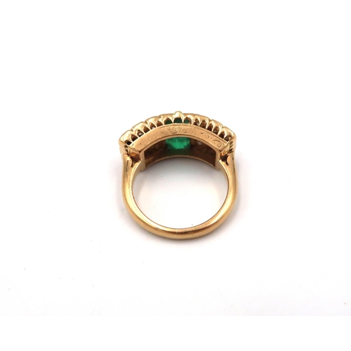 193 - An unmarked, possibly 18ct, yellow gold, emerald and diamond ring, the baguette cut emerald flanked ... 