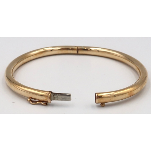 10 - A 9ct gold hinged bangle. Weight 11.89 grams