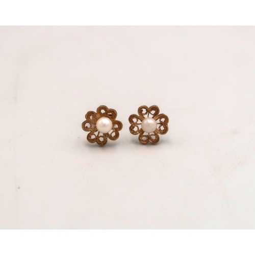 106 - A pair of marked 9ct yellow gold and pearl stud earrings