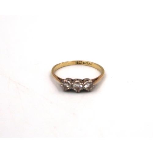 128 - An 18ct yellow gold and platinum three stone diamond ring, size L/M, 1.5grams.