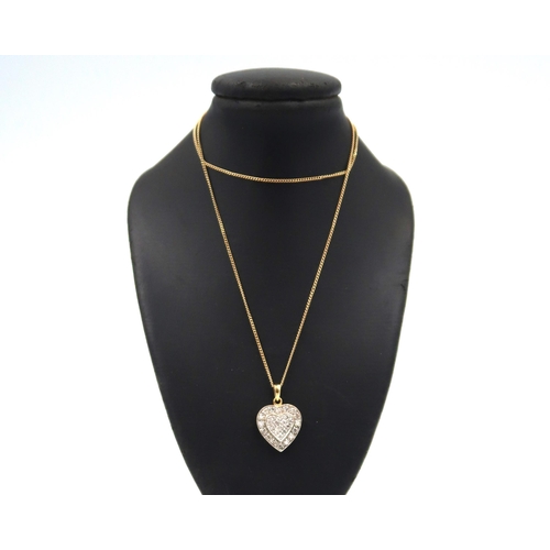 139 - An 18ct yellow gold heart shaped pendant set with small diamonds on a 9ct gold chain