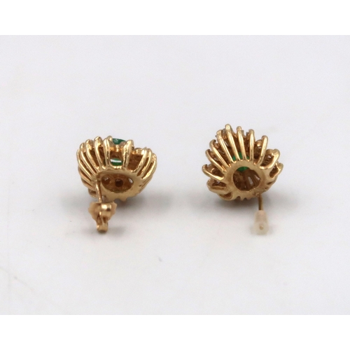 144 - A pair of emerald and diamond cluster earrings. Test 14ct gold or higher. Weight 5.57 grams