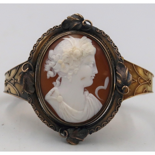 159 - A mourning bangle, with central revolving oval shell cameo panel with reverse obituary compartment. ... 