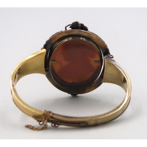 159 - A mourning bangle, with central revolving oval shell cameo panel with reverse obituary compartment. ... 