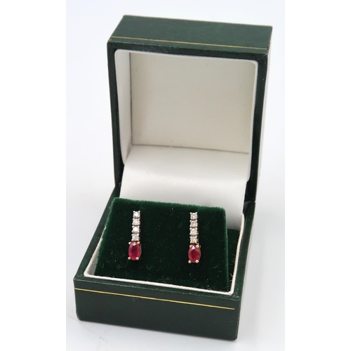 24 - A pair of ruby and diamond drop earrings, Stamped 9K. 0.10ct. Weight 1.44 grams