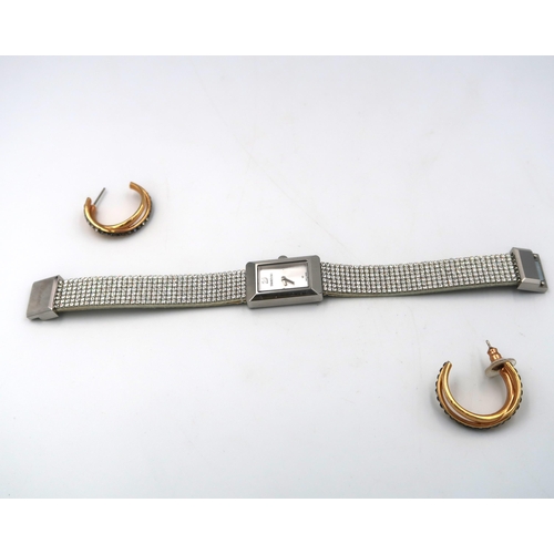 255 - A Swarovski white metal cased ladies wristwatch and earrings NO 5209187, not running in saleroom may... 