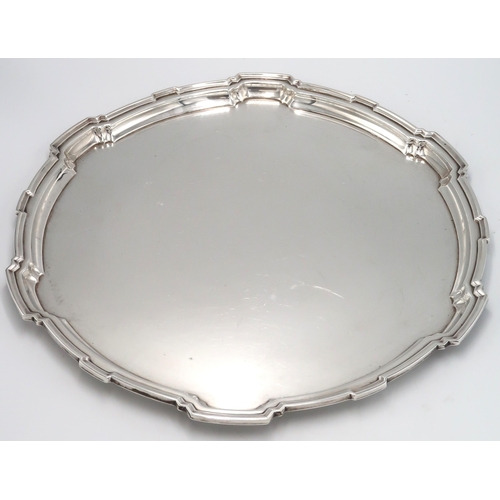 326 - A Silver hallmarked tray pie crust edge raised on four supports. 44 Troy Oz