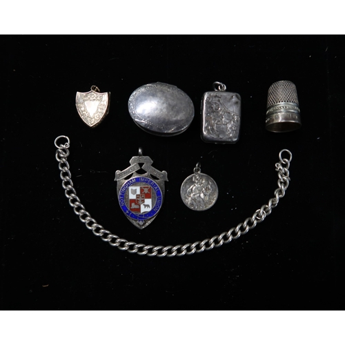 341 - A silver hallmarked pill box of oval form, a hinged locket, a thimble a white metal chain, yellow me... 