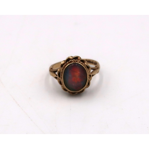 4 - A 9ct gold oval opal triplet ring, the opal displaying vivid colours with some cracks and crazing, s... 