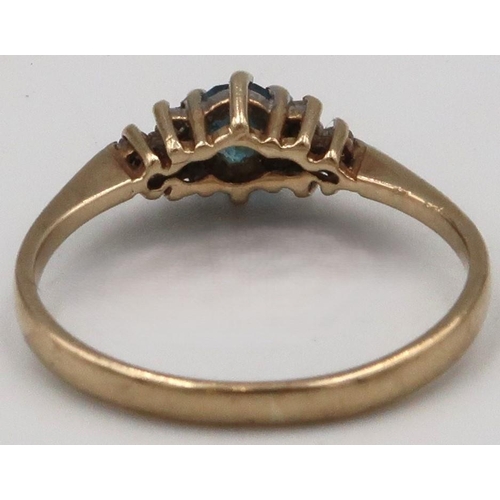 40 - A 9ct gold blue gem believed to be topaz, and diamond dress ring. Size N. Weight 1.65 grams.