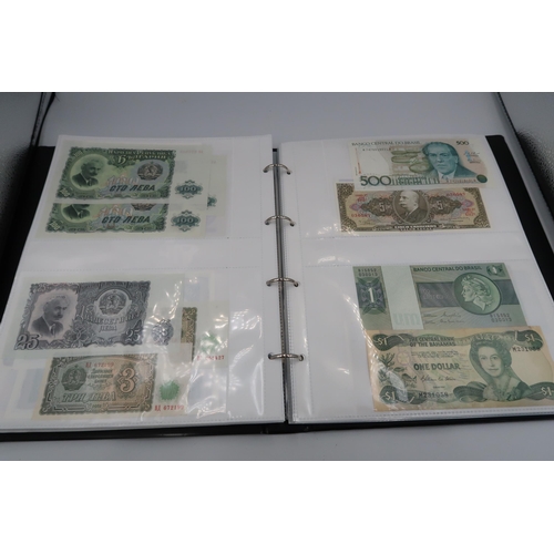 402 - An album containing Seventy seven pages of World banknotes including £1 and £5 examples in consecuti... 