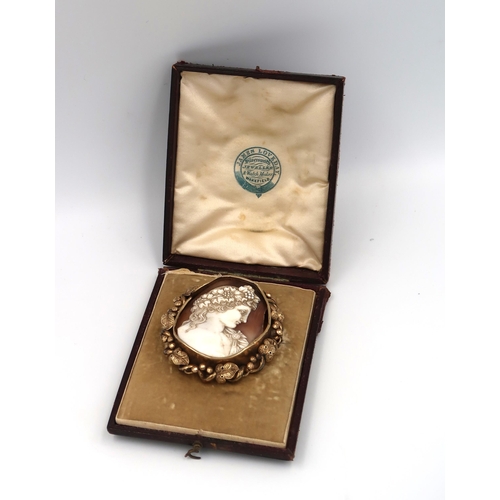 44 - A shell cameo brooch within a frame with leaf decoration. Frame requires repair. Tests 9ct. Weight 2... 