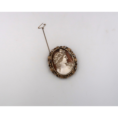 44 - A shell cameo brooch within a frame with leaf decoration. Frame requires repair. Tests 9ct. Weight 2... 