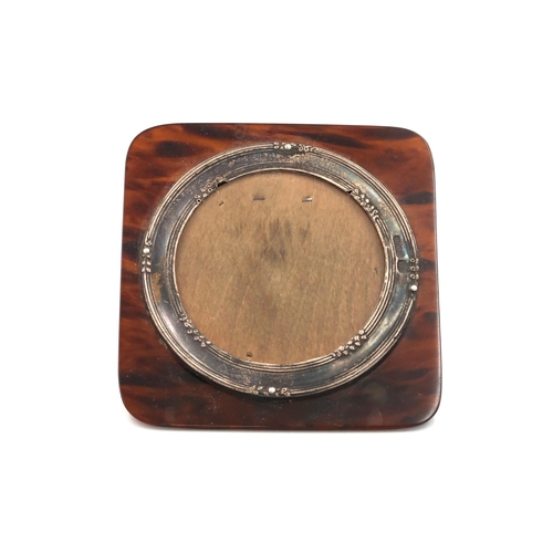 447 - A silver hallmarked circular photo frame on on tortoiseshell baking, overall dimension 8.5cm x 8cm