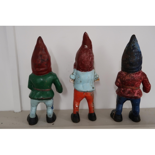 466 - Three cast iron garden Gnomes each one 29cm high