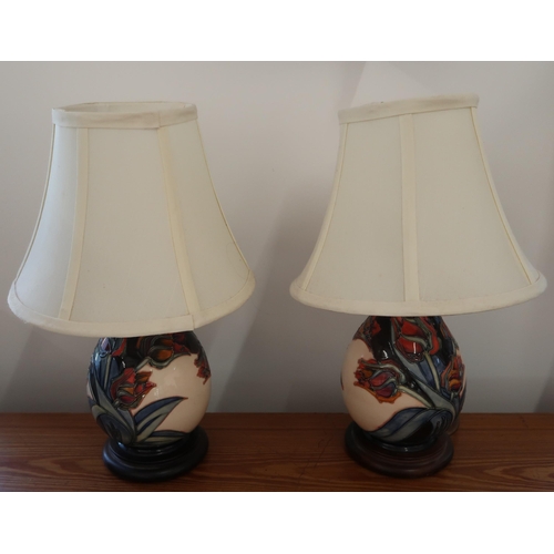 478 - A pair of Moorcroft table lamps in Red Tulip pattern, 32cm high x 25cm diameter