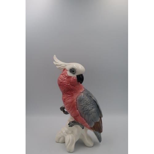 486 - A Beswick cockatoo in glazed grey, white and pink. 30cm high.