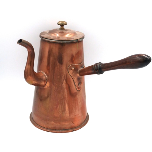 489 - A vintage copper side pouring hot water kettle with wooden handle. 27cm high with a 15cm diameter