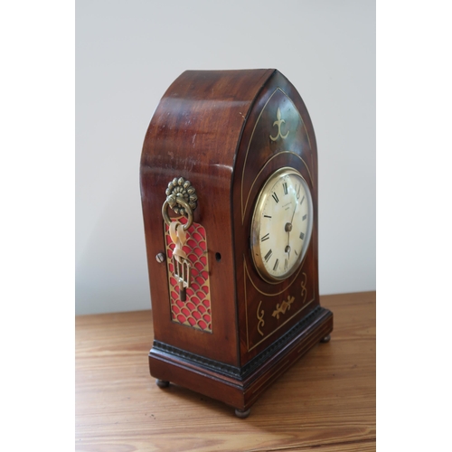 619 - A mahogany case with brass inlay, 8 day gothic style mantle clock