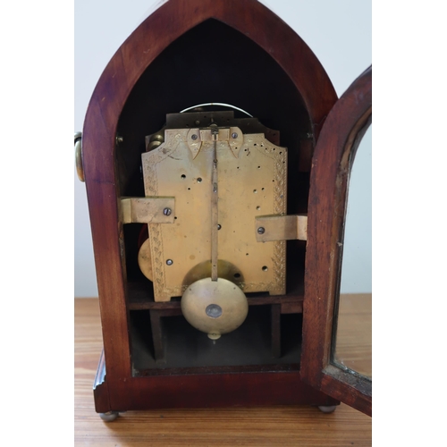 619 - A mahogany case with brass inlay, 8 day gothic style mantle clock