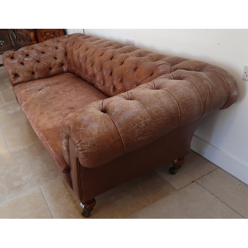 639 - A 19th century Howard style country house large button back Chesterfield settee with a nice faded pa... 