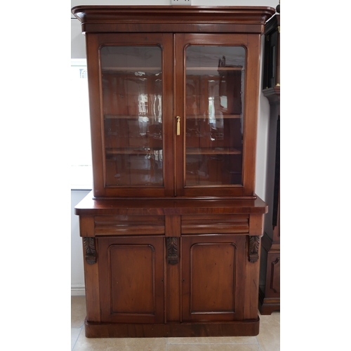 644 - A 19th century mahogany cupboard bookcase with two glazed doors above two drawers and two cupboard d... 