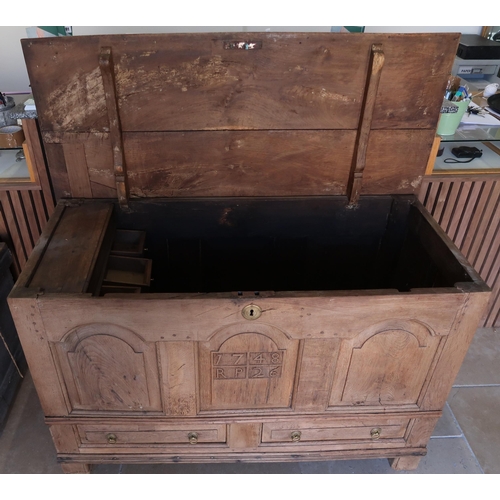 649 - An 18th century oak mule chest, the front carved with the date 1728 RP. 120cm wide x 79cm high x 53c... 