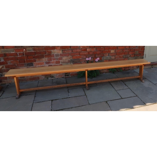 661 - A Oak bench removed from the Leys school dining hall. 2800cm long x 48cm high