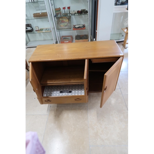 668 - An Ercol blonde elm Windsor Centenary Cabinet of two doors over single drawer flanked by door raised... 