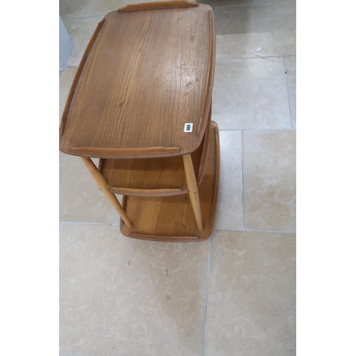 669 - An Ercol blonde elm Windsor three tier drinks trolley raised on casters. 71cm long x 46cm wide x 76c... 