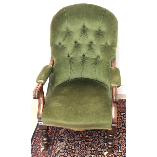 680 - A Victorian green upholstered button back armchair with mahogany frame, overstuffed seat raised on t... 