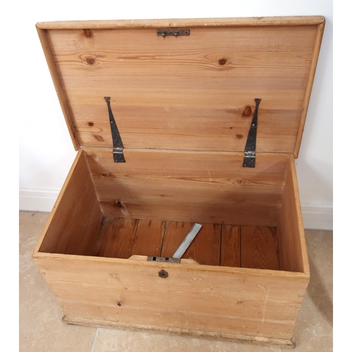 685 - A rustic pine lift top trunk with metal handles. 78cm x 47cm x 43cm high.