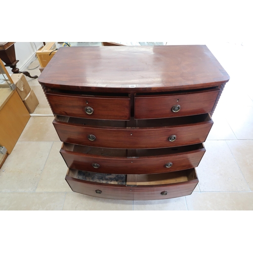 686 - An early Victorian mahogany bow front chest of two short over three long drawers, the top with cross... 