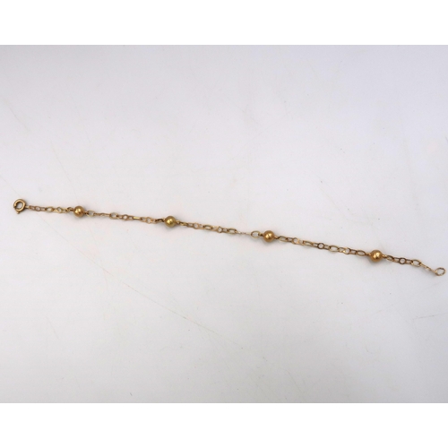 8 - A fancy link and ball bracelet, with foreign marks, tests 18ct, weight 3.0 grams, 18cm long.