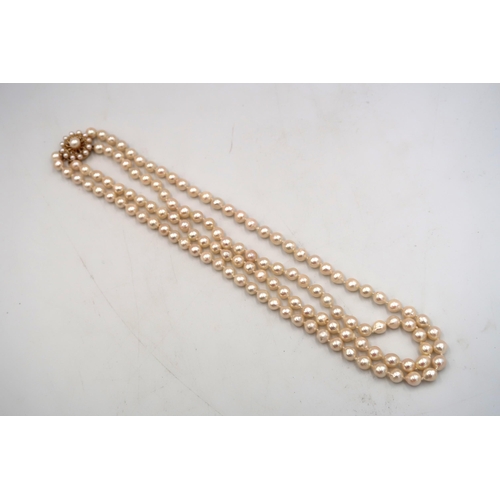 86 - A two row freshwater pearl necklace with cluster clasp stamped 9ct, bright lustre to pearls