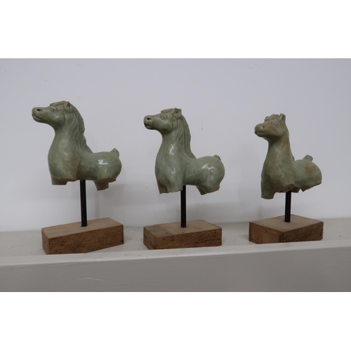 495 - Three soapstone carved statuette of horses, South East Asian origin, on pedestals with plinths below