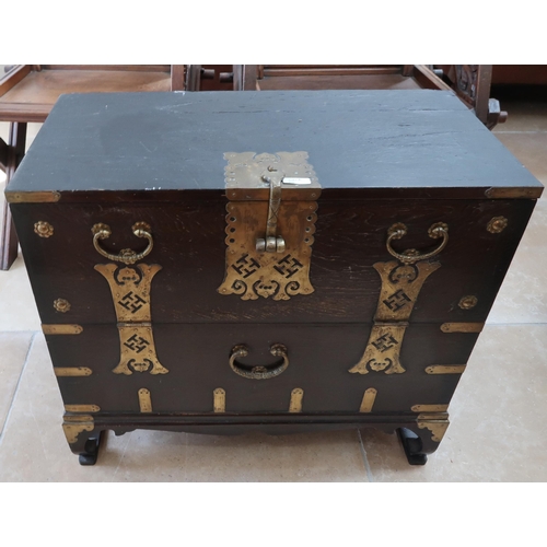 621A - Early 20th century Korean full front dark lacquered chest with decorative brass handles raised on br... 