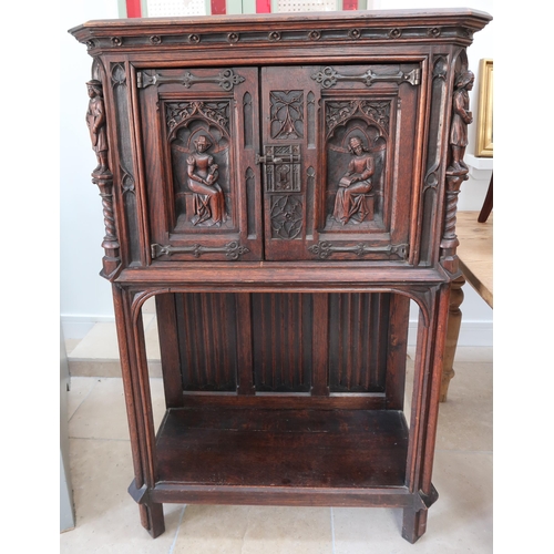 650A - A 20th century Gothic style carved oak two door cabinet - Height 138cm x Width 91cm x Depth 45cm