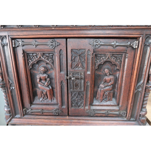 650A - A 20th century Gothic style carved oak two door cabinet - Height 138cm x Width 91cm x Depth 45cm