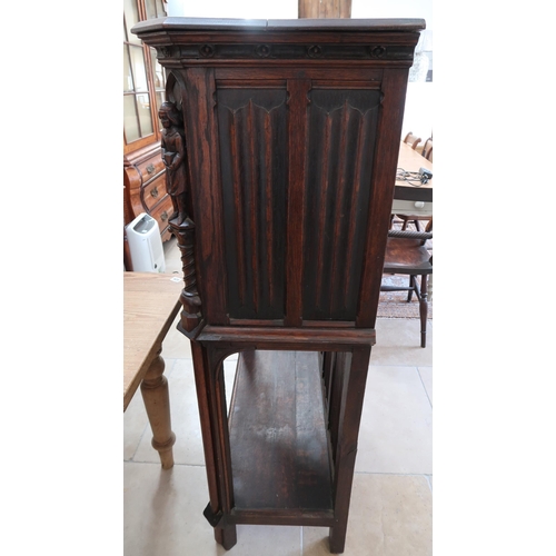 650A - A 20th century Gothic style carved oak two door cabinet - Height 138cm x Width 91cm x Depth 45cm