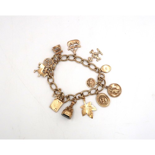 203 - A 9ct gold charm bracelet with 12 charms - approx total weight 27 grams