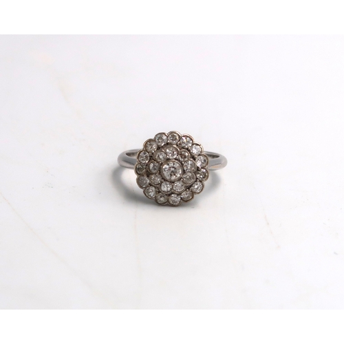 10 - An old cut diamond circular double cluster ring. Estimated total diamond weight 1ct. Estimated G/H c... 