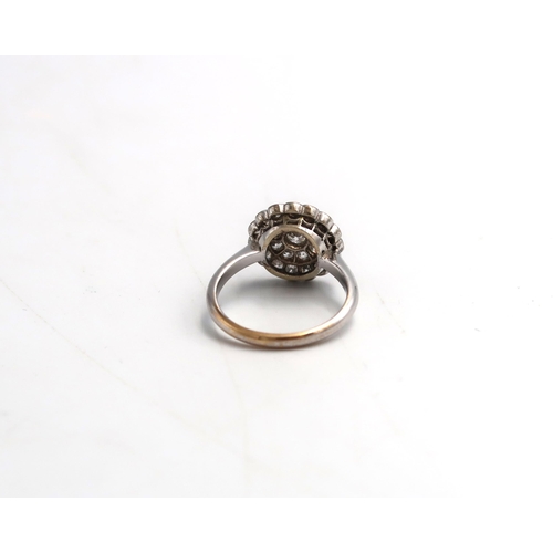 10 - An old cut diamond circular double cluster ring. Estimated total diamond weight 1ct. Estimated G/H c... 