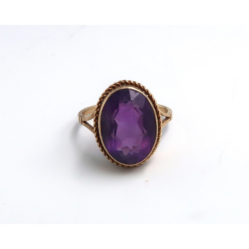 107 - An oval amethyst single stone ring set in 9ct yellow gold - ring size P - approx weight 4.2 grams