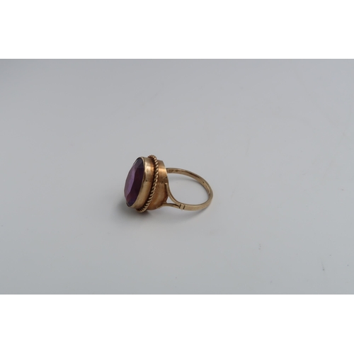 107 - An oval amethyst single stone ring set in 9ct yellow gold - ring size P - approx weight 4.2 grams