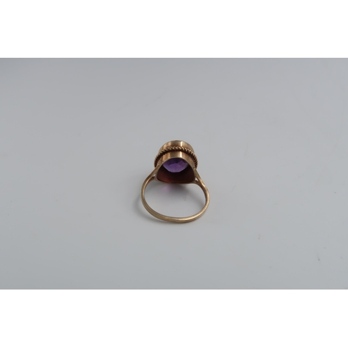 107 - An oval amethyst single stone ring set in 9ct yellow gold - ring size P - approx weight 4.2 grams