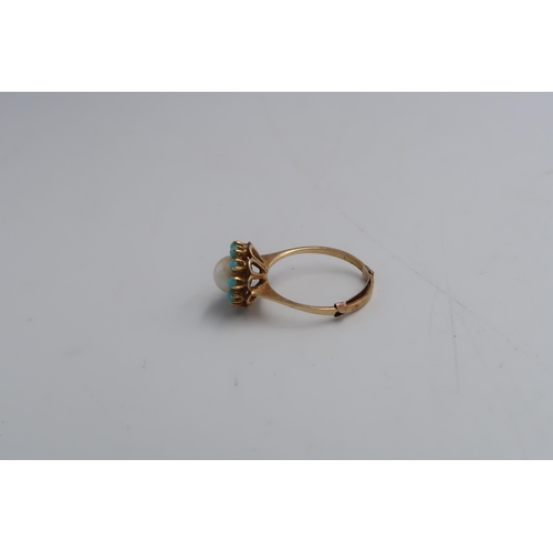 108 - A 9ct yellow gold ring set with a central pearl within a turquoise cabochon surround, one stone miss... 