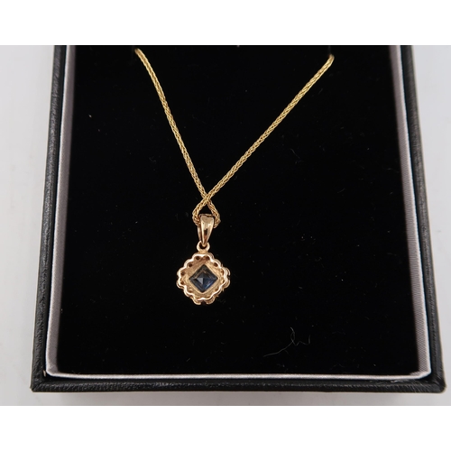 121 - A 9ct yellow gold sapphire and diamond pendant on a 9ct gold chain - head size approx 10mm x 10mm - ... 