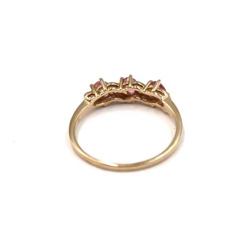 122 - A 9ct yellow gold three stone pink tourmaline ring - head size approx 18mm x 5mm - ring size approx ... 