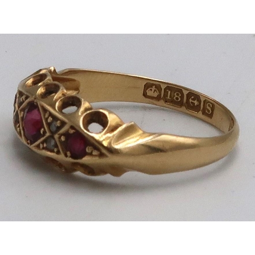 13 - An 18ct yellow gold dress ring  with three rubies and four small diamonds, ring size K, approx 2.2 g... 